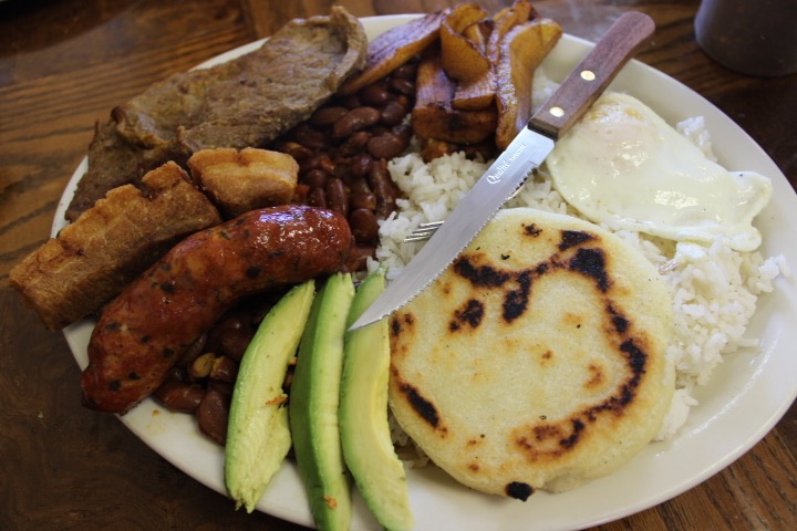 The bandeja paisa at Andinitas, 4139 Carriage Square in Salt Lake City, includes steak, rice, red beans, a fried egg, fried sweet plantains, chicharrón Colombiano (Colombian-style fried pork belly), Colombian sausage, avocado and an arepa (a corn cake made from a special precooked corn flour). (Yvette Cruz, KSL.com)