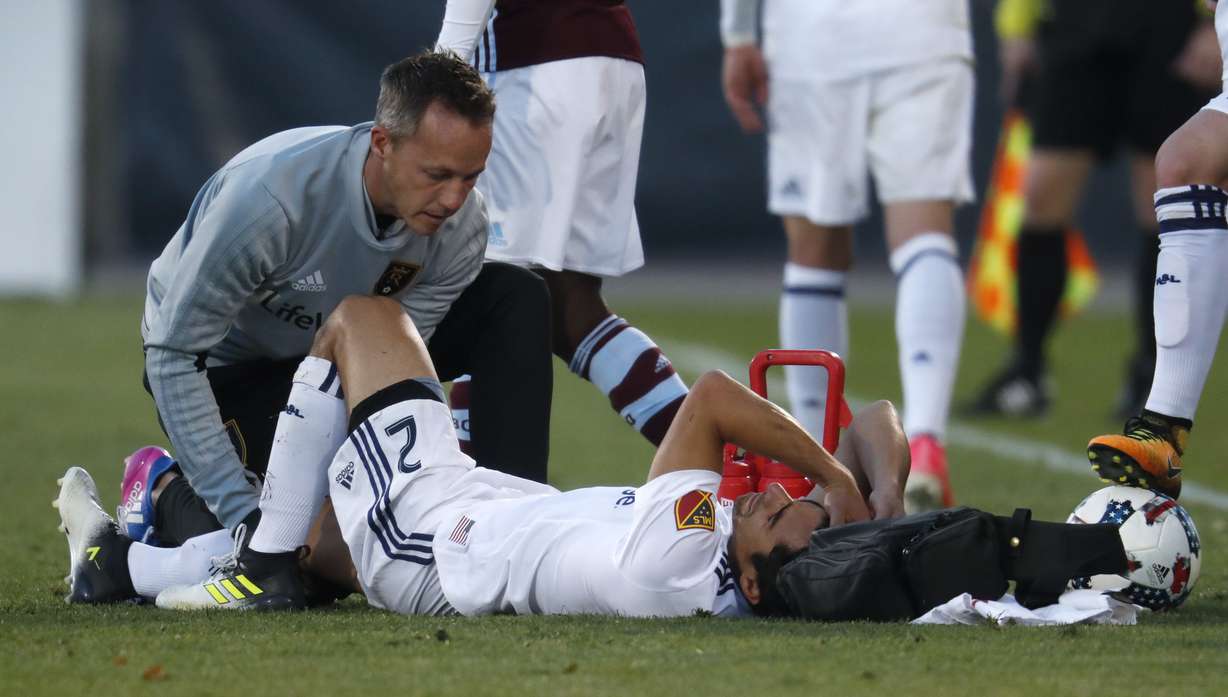 RSL defender Tony Beltran is attended by the athletic training staff during the game against Colorado Rapids, Sunday, Oct. 15, 2017 in Commerce City, Colorado. (Photo: David Zalubowski, AP Photo)