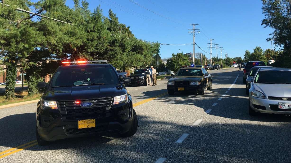 The Latest: Suspect discarded gun, ran when he saw police