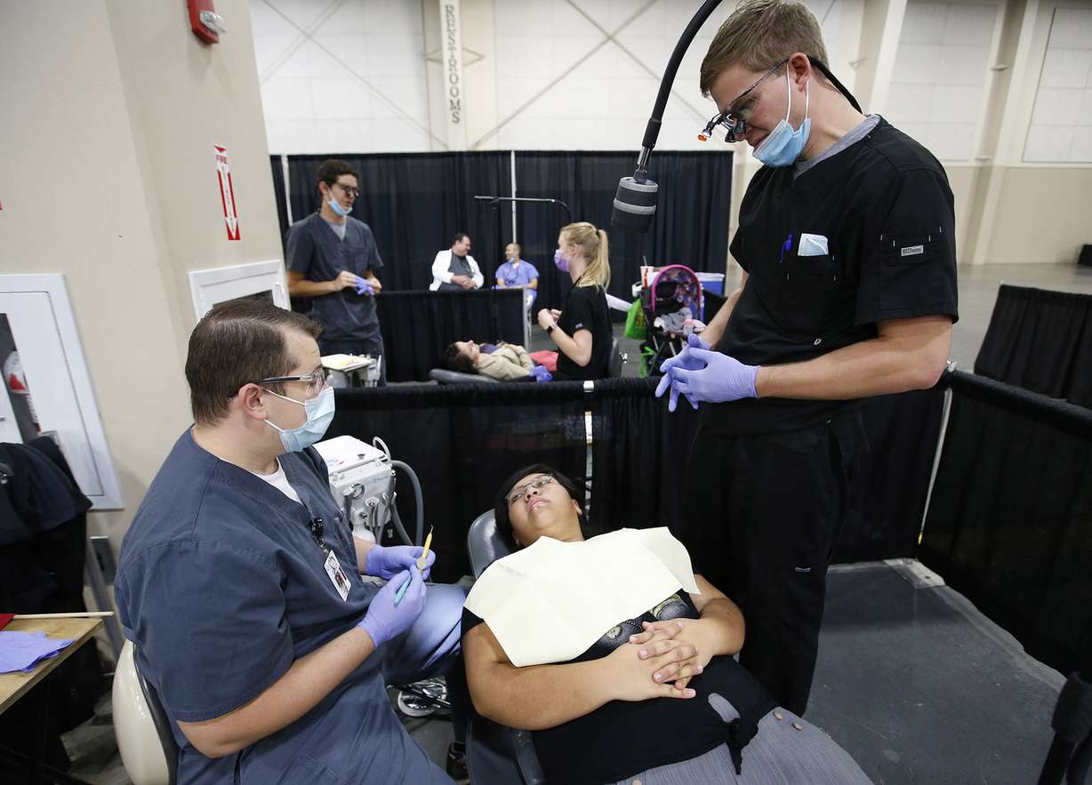 Dallin Gomez and Brennan Stringham perform a dental exam for Eva Aquino at the health and dental fair for the Hispanic community at South Towne Expo Center in Sandy on Saturday, Oct. 21, 2017. (Photo: Jeffrey D. Allred, KSL)