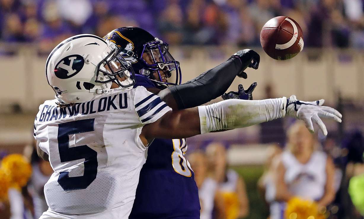 BYU's Dayan Ghanwoloku (5) knocks the ball way from East Carolina's Trevon Brown (88) during the second half of an NCAA college football game in Greenville, N.C., Saturday, Oct. 21, 2017. (AP Photo/Karl B DeBlaker)