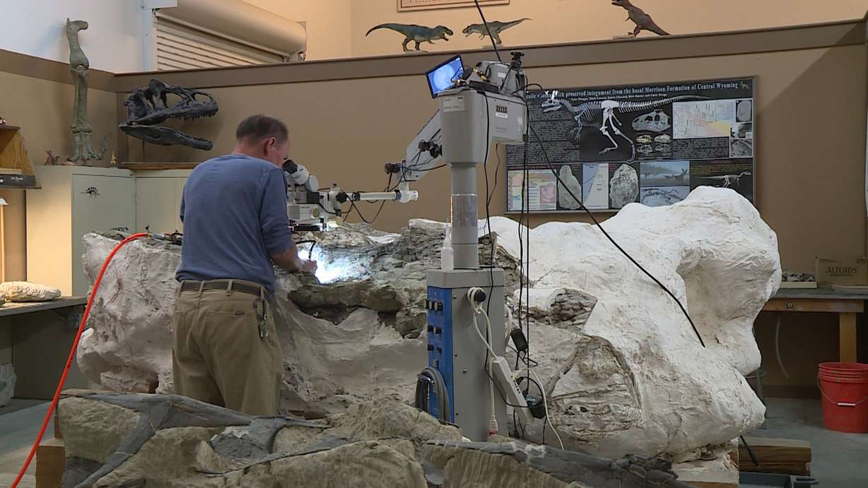 Scott Madsen works on the nine ton block of rock at the Museum of Ancient Life at Thanksgiving Point. (Photo: Ray Boone, KSL TV)