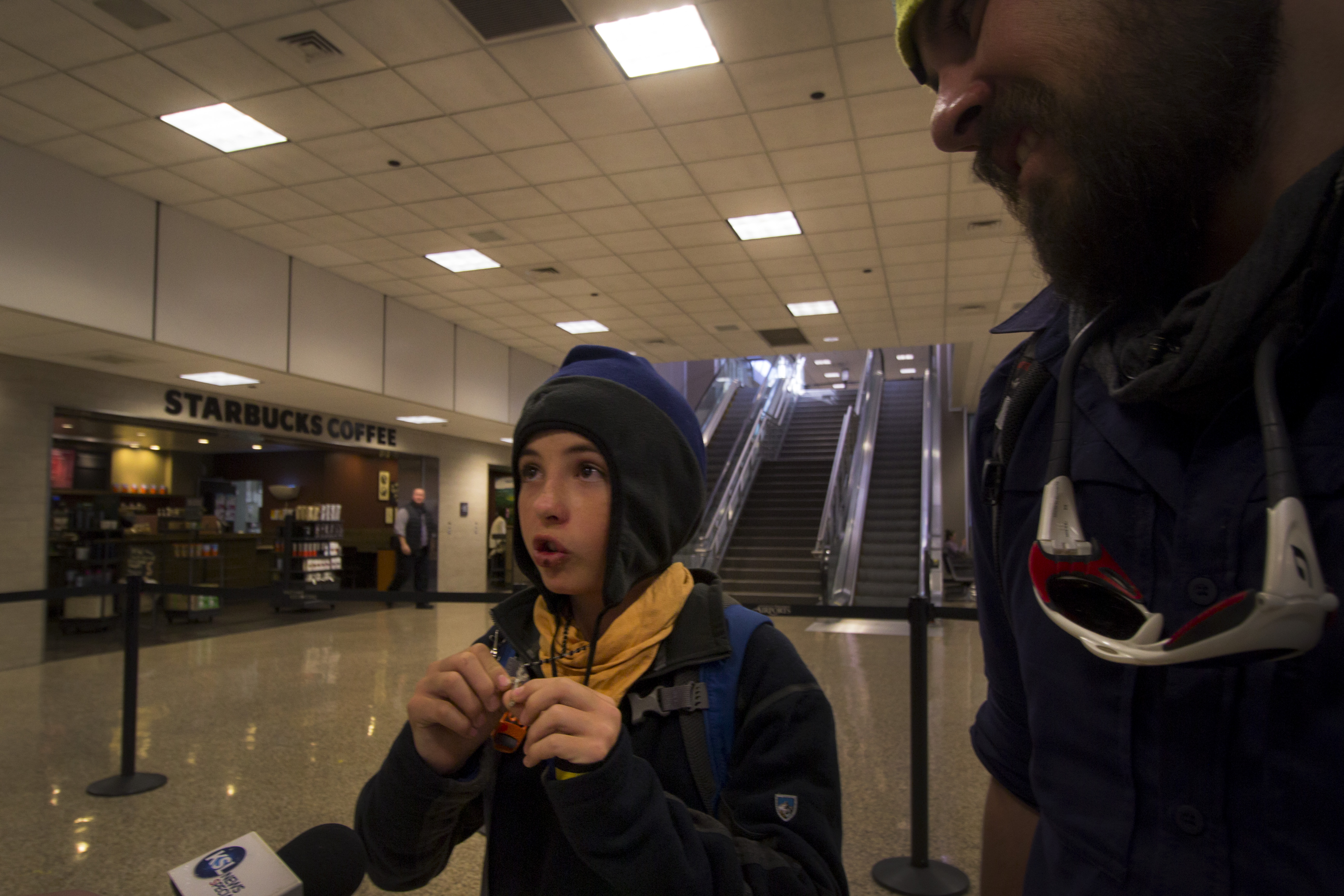 Jace Chapman, left, shows his Cross necklace while telling his story after arriving back in Salt Lake City on Wednesday, Oct. 25, 2017. (Photo: Carter Williams, KSL.com)