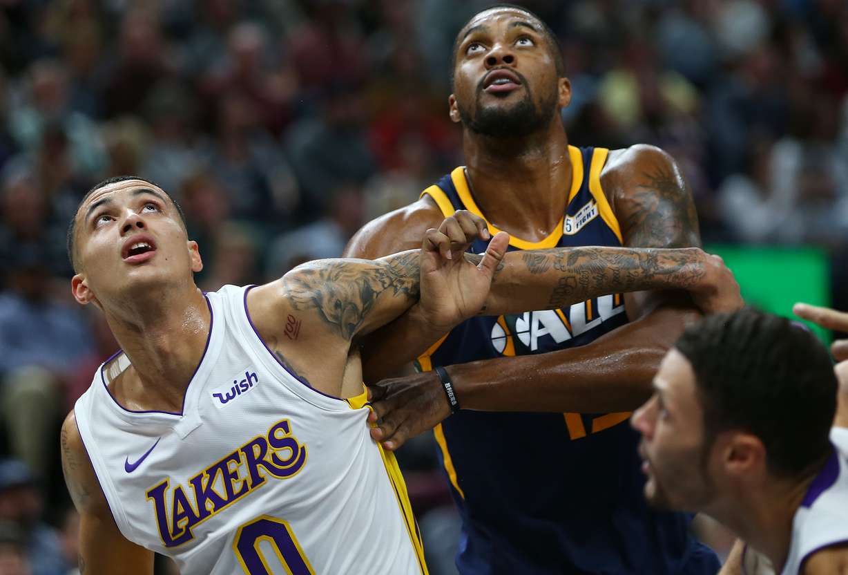 Former University of Utah Basketball player and current Los Angeles Lakers forward Kyle Kuzma (0) battles Utah Jazz forward Derrick Favors (15) for position during a free throw as the Utah Jazz and the LA Lakers play at Vivint Smart Home Arena in Salt Lake City on Saturday, Oct. 28, 2017. (Photo: Scott G Winterton, Deseret News)
