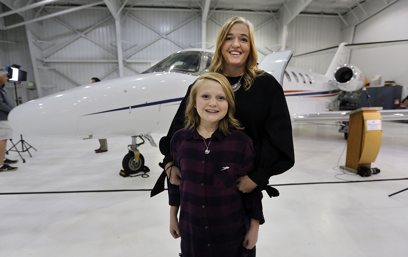 Kina Jewkes, a Primary Children's Hospital liver transplant recipient, poses for a photo with her mother, Jennifer, as Intermountain Healthcare introduces a new Life Flight jet in Salt Lake City on Monday, Oct. 30, 2017. The jet will be used primarily to retrieve organs for transplantation in the Intermountain West. (Photo: Ravell Call, KSL)