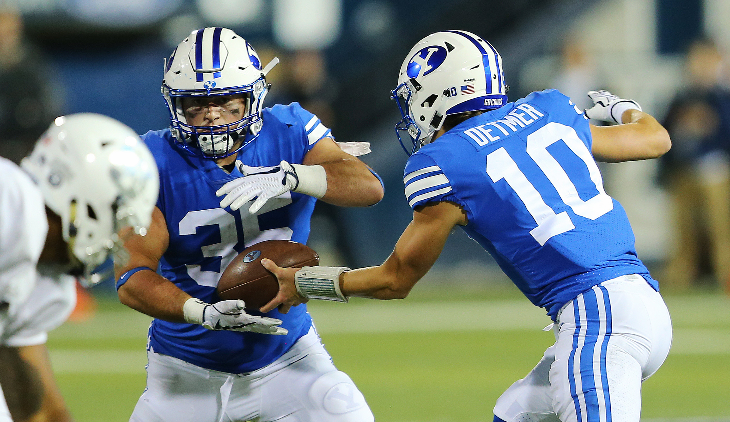 BYU quarterback Koy Detmer Jr. (10) hands the ball off to BYU fullback Brayden El-Bakri (35) as USU and BYU play at Maverik Stadium in Logan Utah on Friday, Sept. 29, 2017. (Photo: Scott G Winterton, Deseret News)