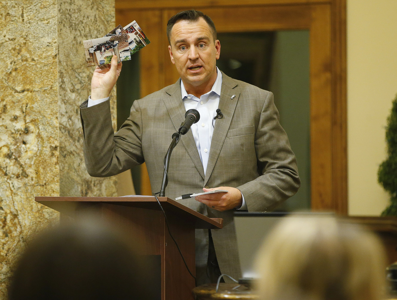 House Speaker Greg Hughes holds crime photographs taken by residents as he speaks during the Ballpark Community Council meeting in Salt Lake City on Thursday, Nov. 2, 2017. Photo: Jeffrey D. Allred, KSL
