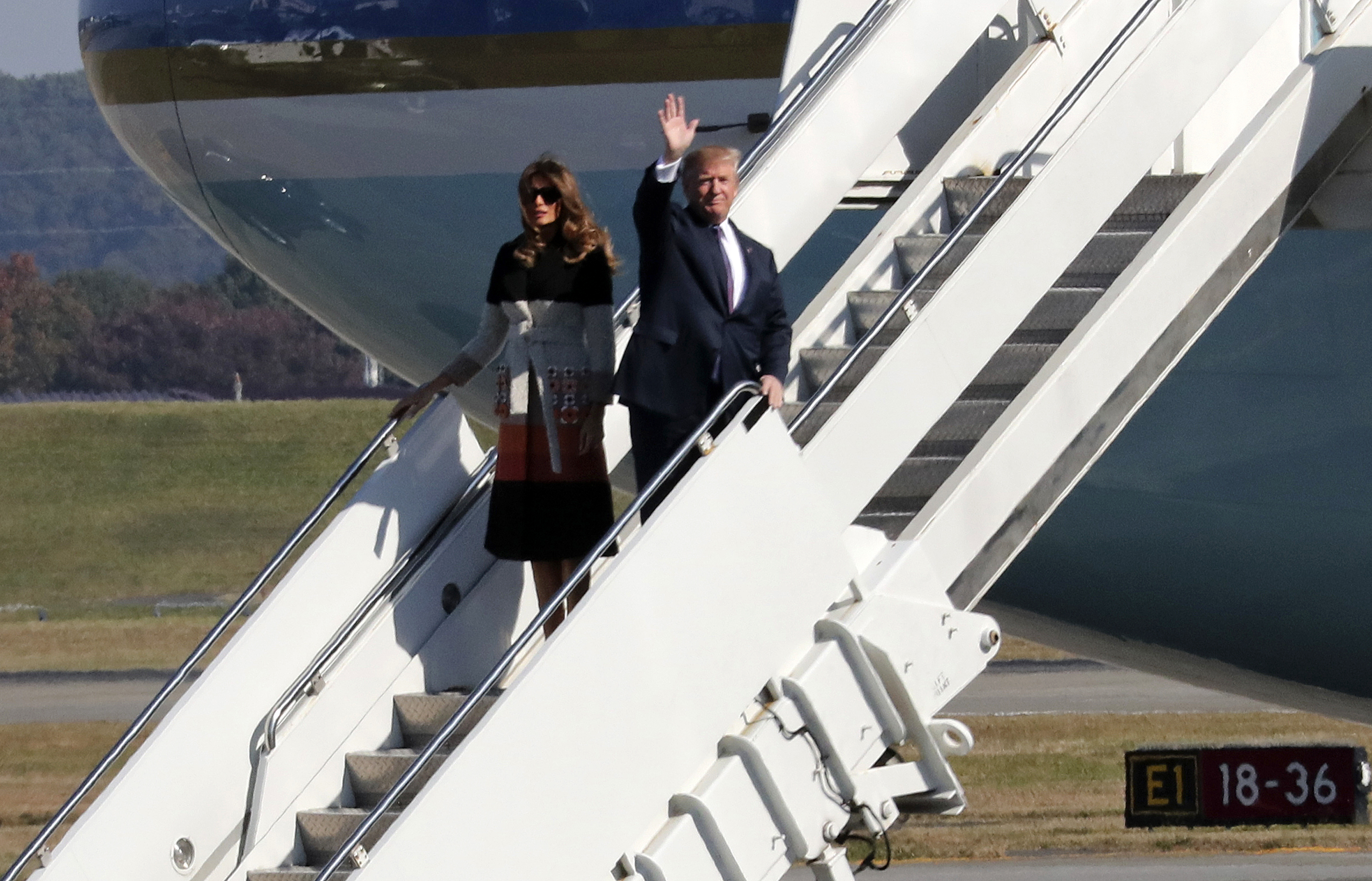U.S. President Donald Trump, waving, and first lady Melania Trump, left, arrive at the U.S. Yokota Air Base, on the outskirts of Tokyo, Sunday, Nov. 5, 2017. President Trump arrived in Japan Sunday on a five-nation trip to Asia, his second extended foreign trip since taking office and his first to Asia. The trip will take him to Japan, South Korea, China, Vietnam and Philippines for summits of the Asia-Pacific Economic Cooperation (APEC) and the Association of Southeast Asian Nations (ASEAN). (AP Photo/Eugene Hoshiko)