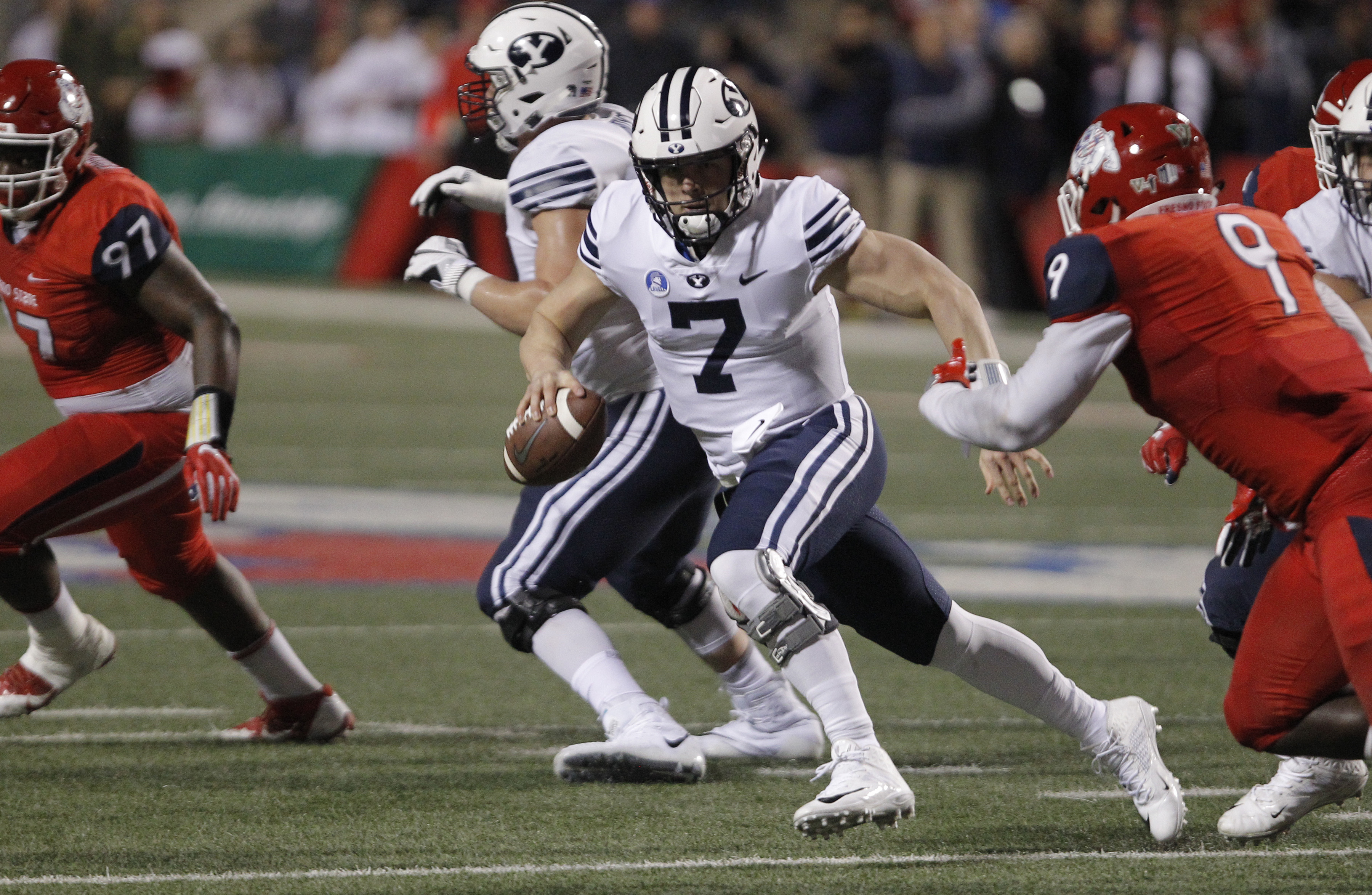 BYU quarterback Beau Hoge tries to avoid Fresno State's Jeffrey Allison, right, during the first half of an NCAA college football game in Fresno, Calif., Saturday, Nov. 4, 2017. (Photo: Gary Kazanjian, AP)