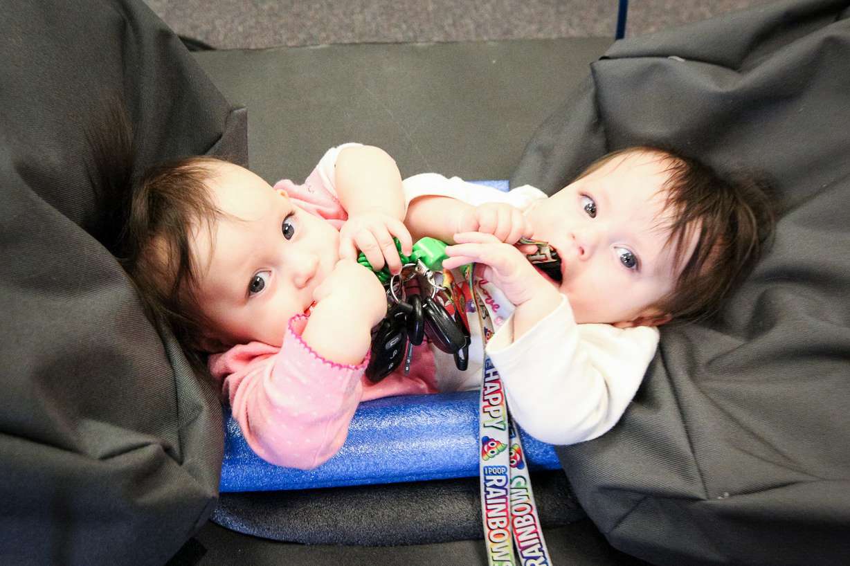 Conjoined twins Callie, left, and Carter Torres relax in their specially made baby jumper at the Utah Center for Assistive Technology in Salt Lake City on Monday, Nov. 6, 2017. The girls share a single set of legs and their organs from the belly button downward. (Photo: Adam Fondren, KSL)