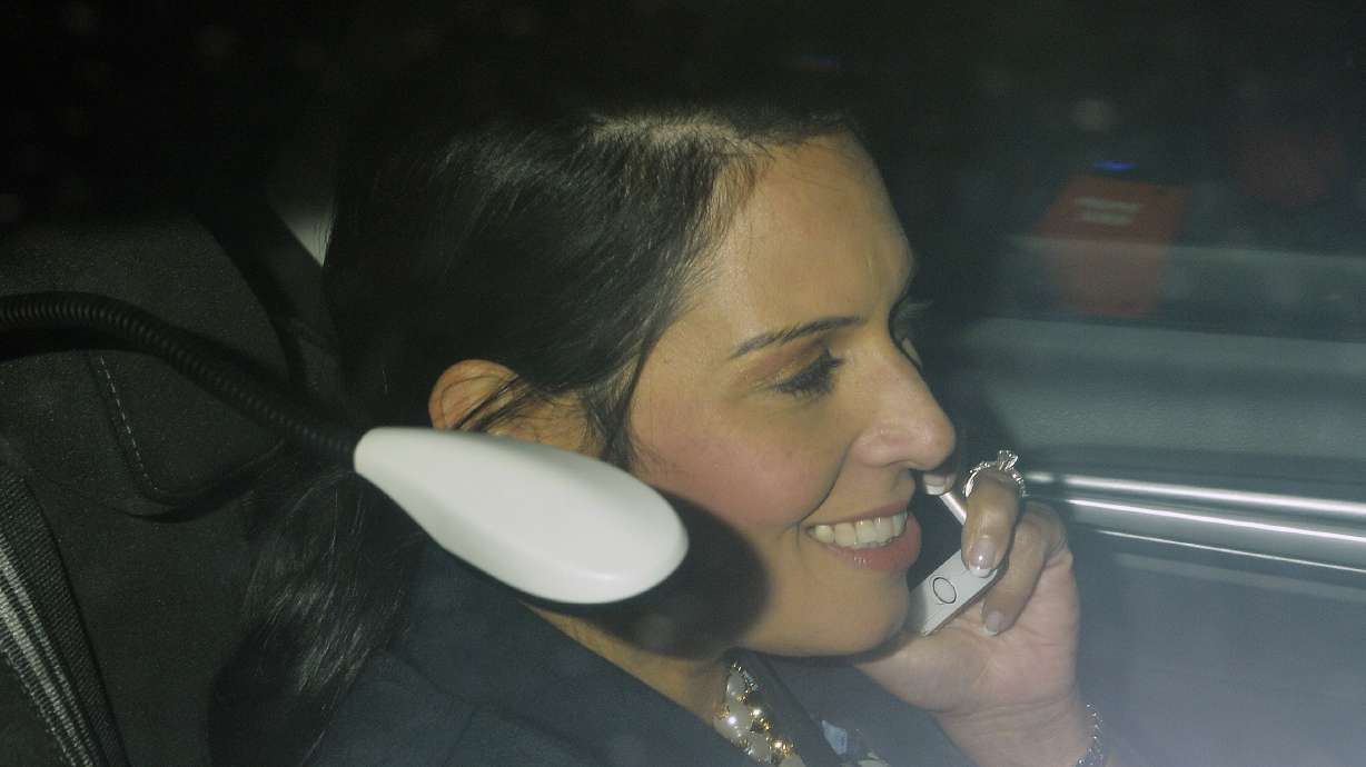 The Latest: UK Cabinet minister quits over Israel meetings
