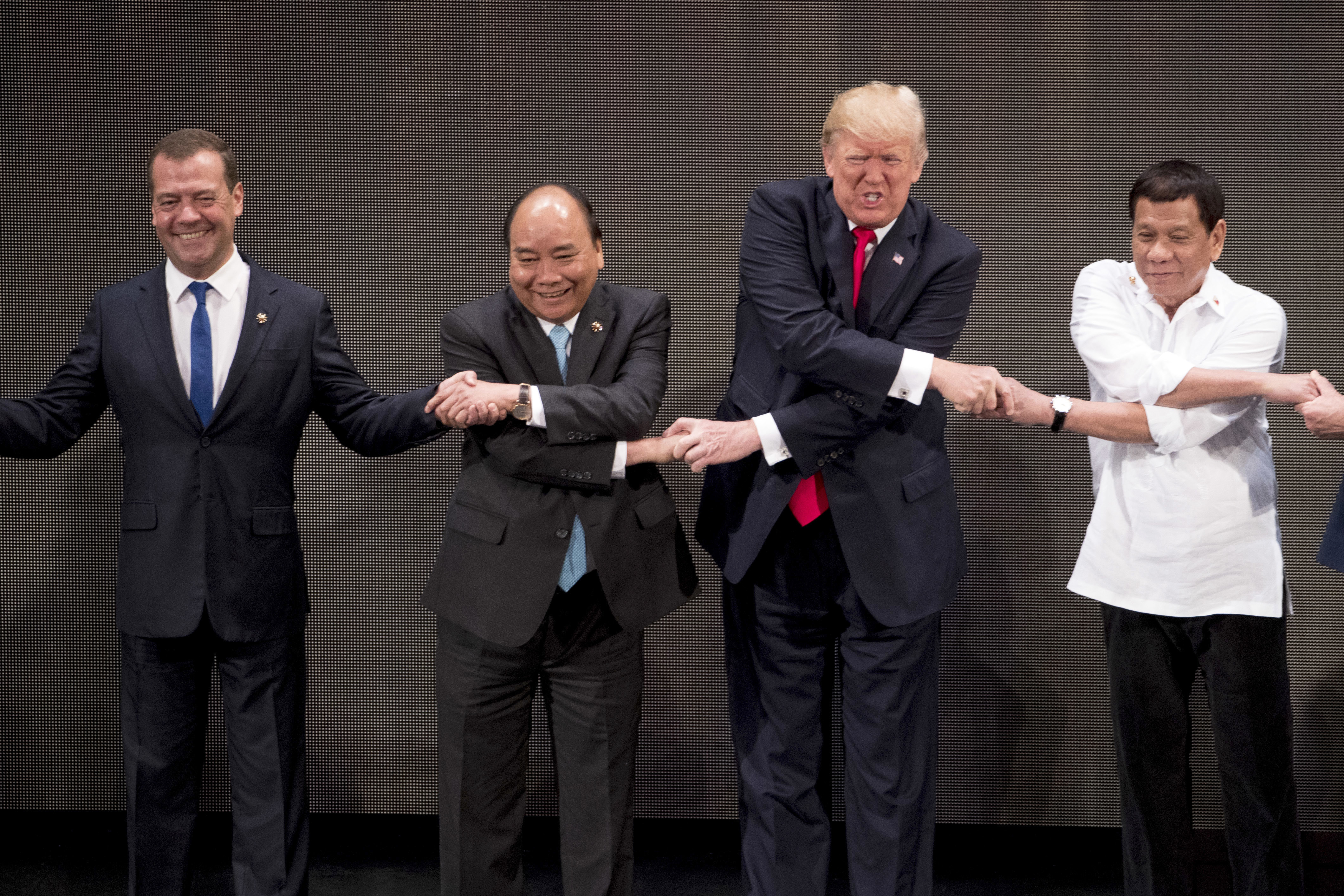Trump's handshake challenge: He grimaces, grins, grips