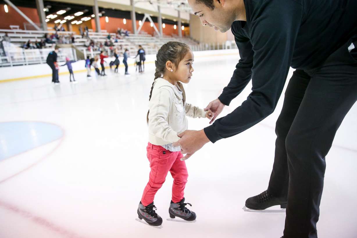 Gene Holmes helps Adalyn Valdez, 4, while skating at the South Davis Recreation Center in Bountiful on Wednesday, Nov. 15, 2017. To mark the upcoming Disney On Ice show in Salt Lake City, professional skaters from the show gave lessons to children from the Utah Foster Care Foundation. (Photo: Spenser Heaps, KSL)