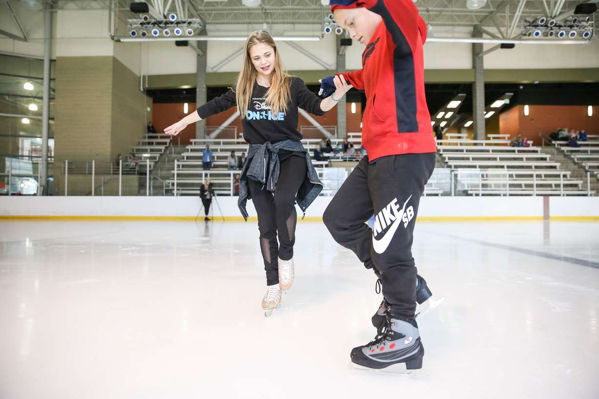 Vika Tugolukova gives some instruction to Isaiah Hansen, 10, while skating at the South Davis Recreation Center in Bountiful on Wednesday, Nov. 15, 2017. To mark the upcoming Disney On Ice show in Salt Lake City, professional skaters from the show gave lessons to children from the Utah Foster Care Foundation. (Photo: Spenser Heaps, KSL)