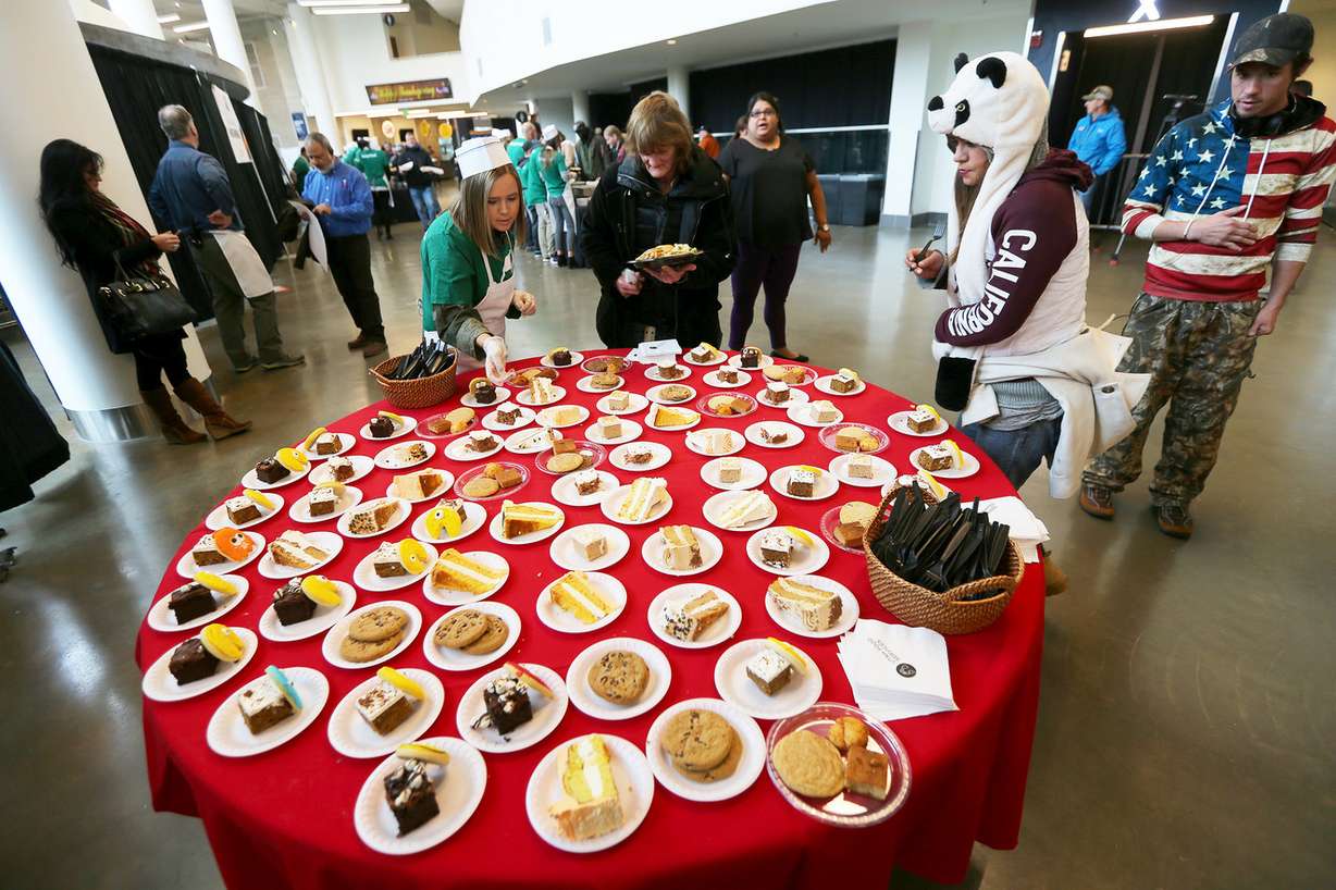 Guests choose a slice of pie as the Miller family, Larry H. Miller Sports & Entertainment employees and select Salt Lake City Stars players serve food at the 19th annual “We Care - We Share” Thanksgiving Dinner for local homeless and low-income individuals at Vivint Smart Home Arena on Monday, Nov. 20, 2017. (Photo: Scott G Winterton, KSL)