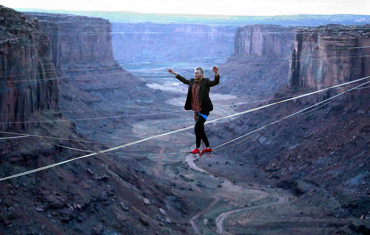 R.J. Roush highlines across the Fruit Bowl, near Canyonlands National Park and Moab, on Monday, Nov. 20, 2017, as several groups converge on the area to celebrate Thanksgiving with extreme sports such as BASE jumping and slackline walking off the canyon walls. (Photo: Kristin Murphy,