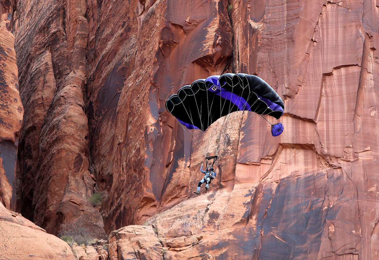 Chuck Moeser BASE jumps off Tombstone with his son, near Moab, on Monday, Nov. 20, 2017, as several groups converge on the area to celebrate Thanksgiving with extreme sports such as BASE jumping and slackline walking off the canyon walls. (Photo: Kristin Murphy, KSL)