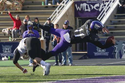Weber State quarterback Stefan Cantwell (11) dives into the end zone scoring a touchdown during the the first half of an NCAA college football game against Idaho State on Saturday, Nov. 18, 2017 in Ogden, Utah. (Photo: Matt Herp, Standard-Examiner via AP)