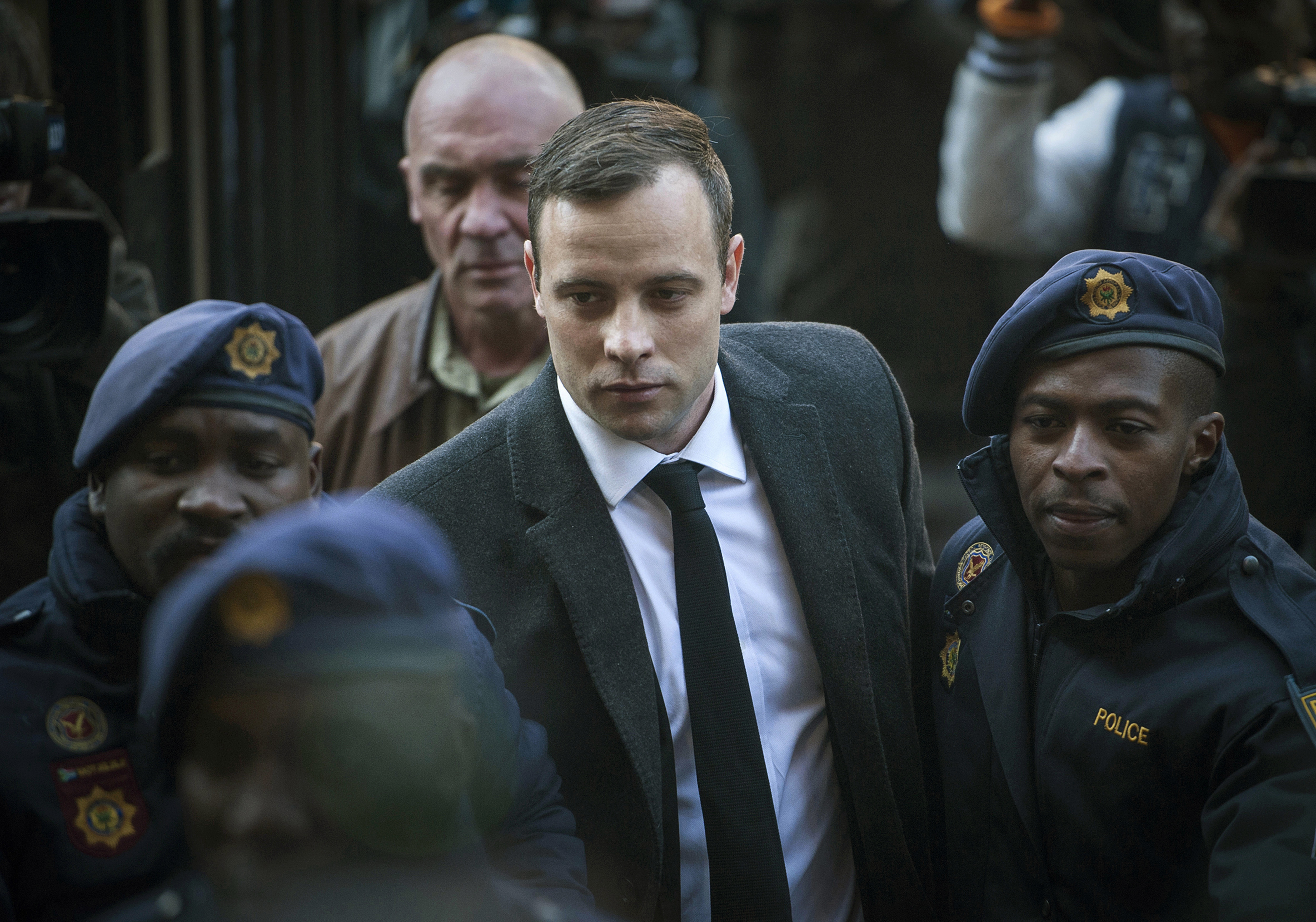 In this July 6, 2016, file photo, Oscar Pistorius, center, arrives at the High Court in Pretoria, South Africa, for a sentencing hearing for the murder of his girlfriend Reeva Steenkamp in his home on Valentine's Day 2013. Pistorius has had his prison sentence extended to 13 years and 5 months in the High Court of Appeal in Bloemfontein Friday, Nov. 24, 2017. (Shiraaz Mohamed, AP Photo, File)