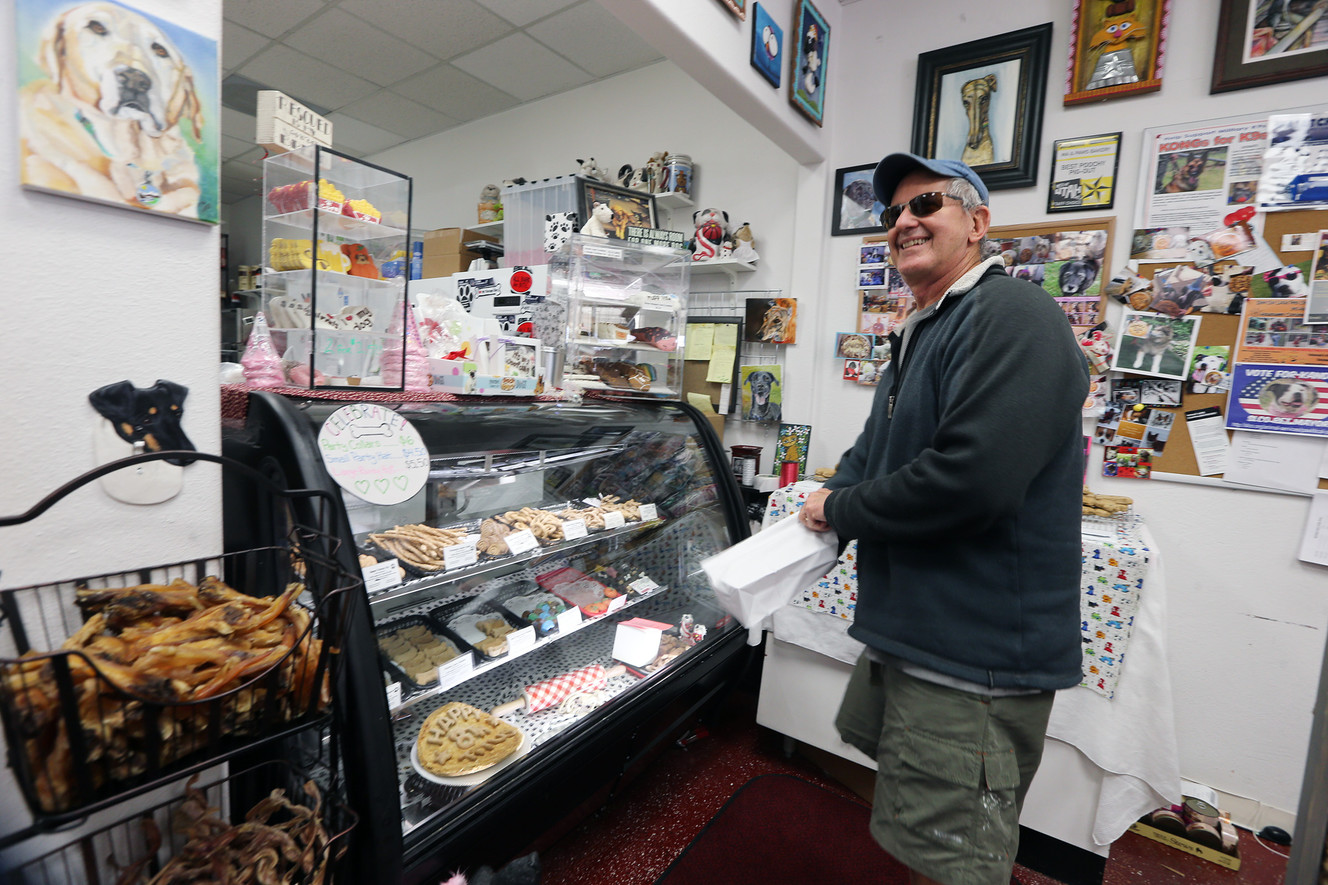 Drew Papadakis picks out a few treats for his dog at Ma and Paws Bakery in Millcreek on Saturday, Nov. 25, 2017. (Photo: Scott G Winterton, KSL)