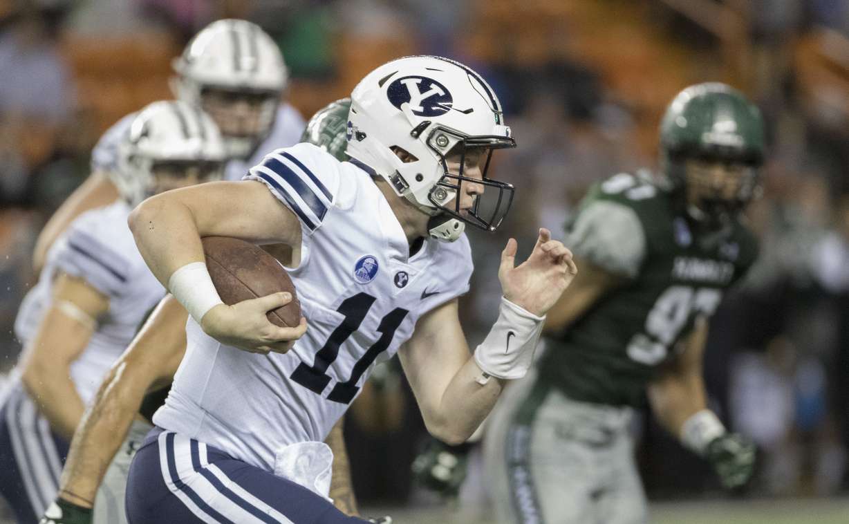 BYU quarterback Joe Critchlow (11) carries the football during the third quarter of an NCAA college football game against Hawaii, Saturday, Nov. 25, 2017, in Honolulu. (Photo: Eugene Tanner, AP)