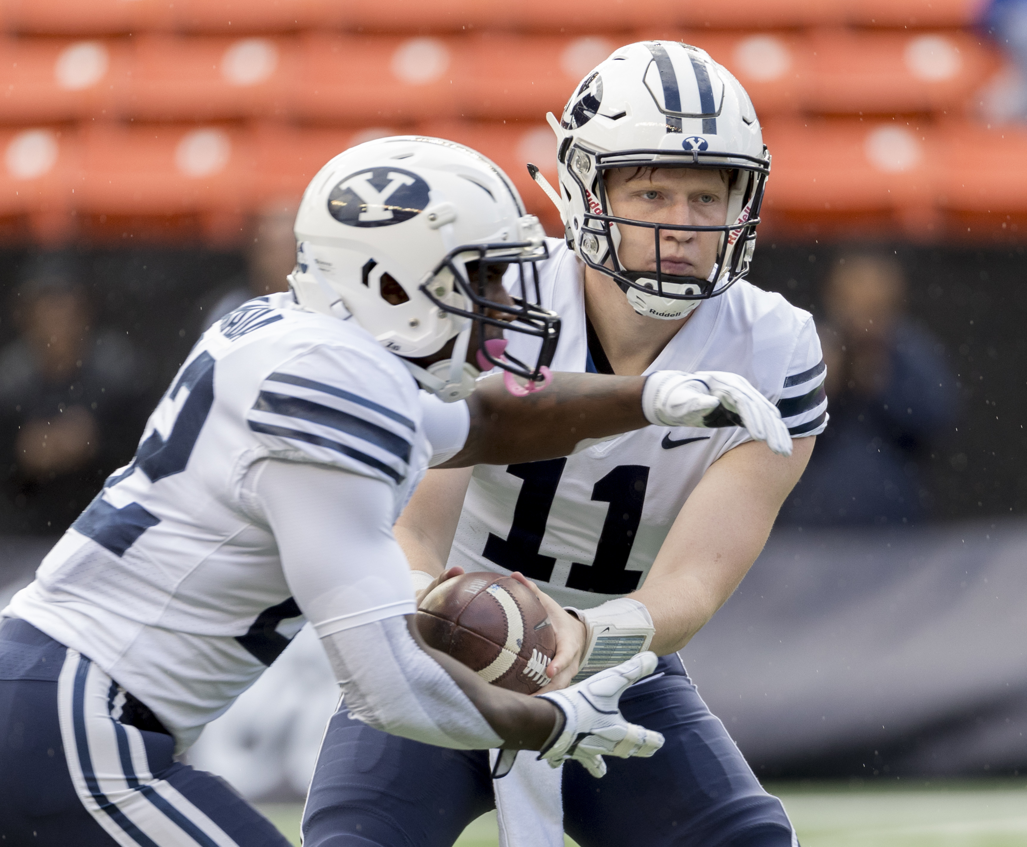 BYU quarterback Joe Critchlow (11) hands off the football to running back Squally Canada (22) in the first quarter of an NCAA college football game, Saturday, Nov. 25, 2017, in Honolulu. (AP Photo/Eugene Tanner)