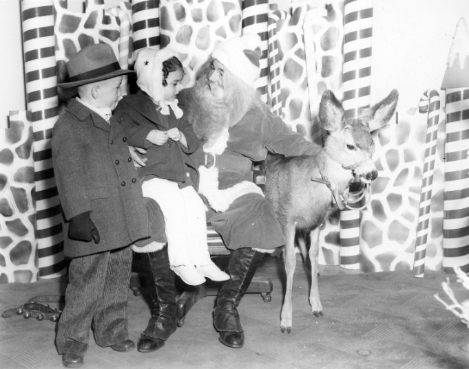 Santa Claus with children and a deer, Dec. 24, 1945. (Photo: Utah Division of State History)