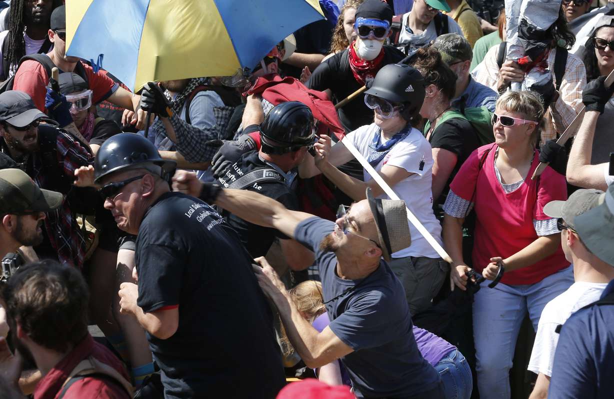 In this Aug. 12 photo, white nationalist demonstrators clash with counter demonstrators at the entrance to Lee Park in Charlottesville, Va. A former federal prosecutor says the law enforcement response to a white nationalist rally this summer in Charlottesville that erupted in violence was a series of failures. (Photo: Steve Helber, AP)