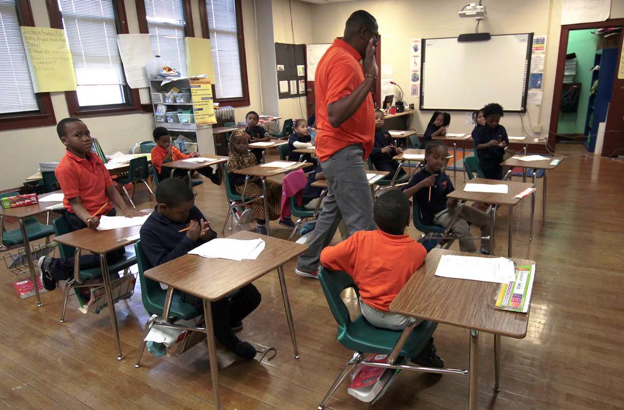In this Oct. 20 photo, first-graders listen to teacher Dwane Davis at Milwaukee Math and Science Academy, a charter school in Milwaukee. Charter schools are among the nation's most segregated, an Associated Press analysis finds — an outcome at odds, critics say, with their goal of offering a better alternative to failing traditional public schools.