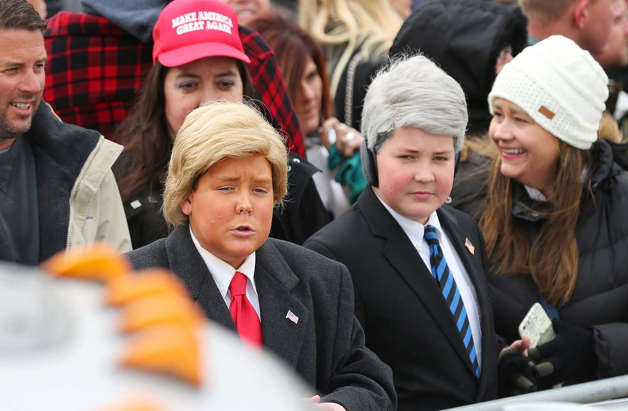Twins Trevor and Tristen Tharp, 16, dressed as President Donald Trump and Vice President Mike Pence, wait for the president arrive in Salt Lake City on Monday, Dec. 4, 2017. Photo: Scott G Winterton, KSL