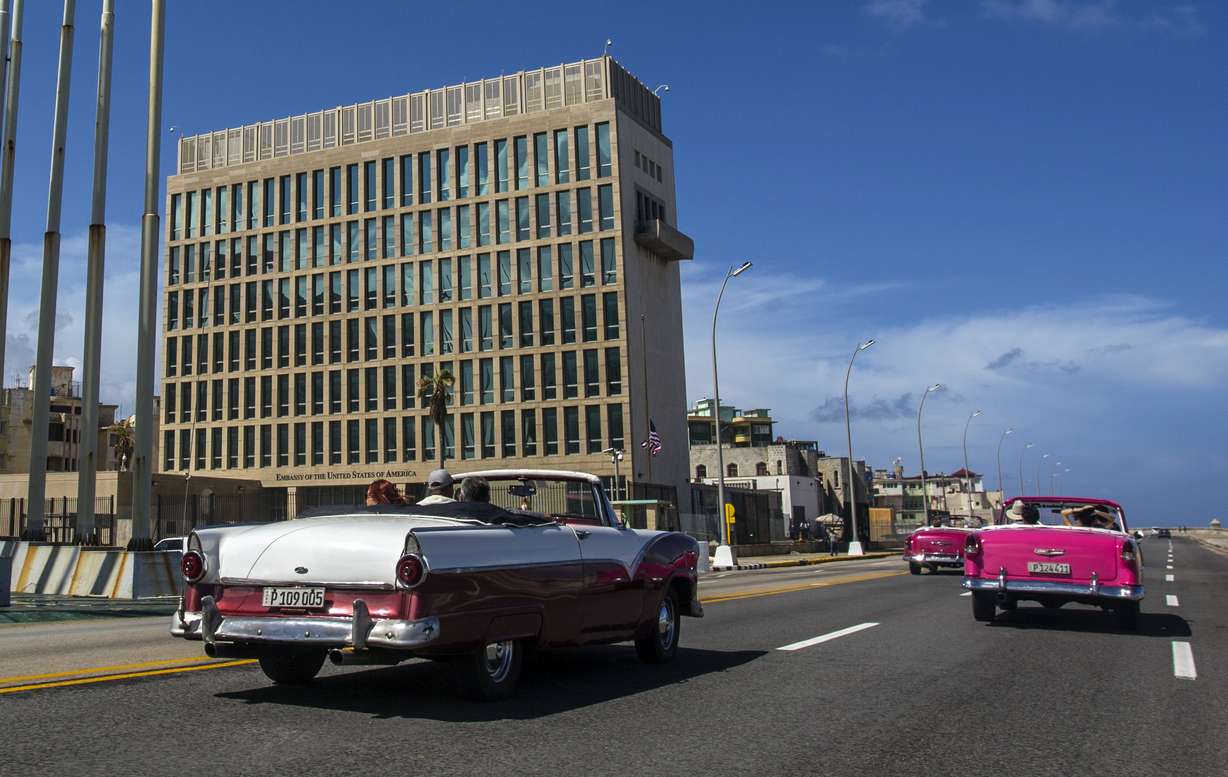 FILE - In this Oct. 3, 2017, file photo, tourists ride classic convertible cars on the Malecon beside the United States Embassy in Havana, Cuba. Photo: AP Photo, File