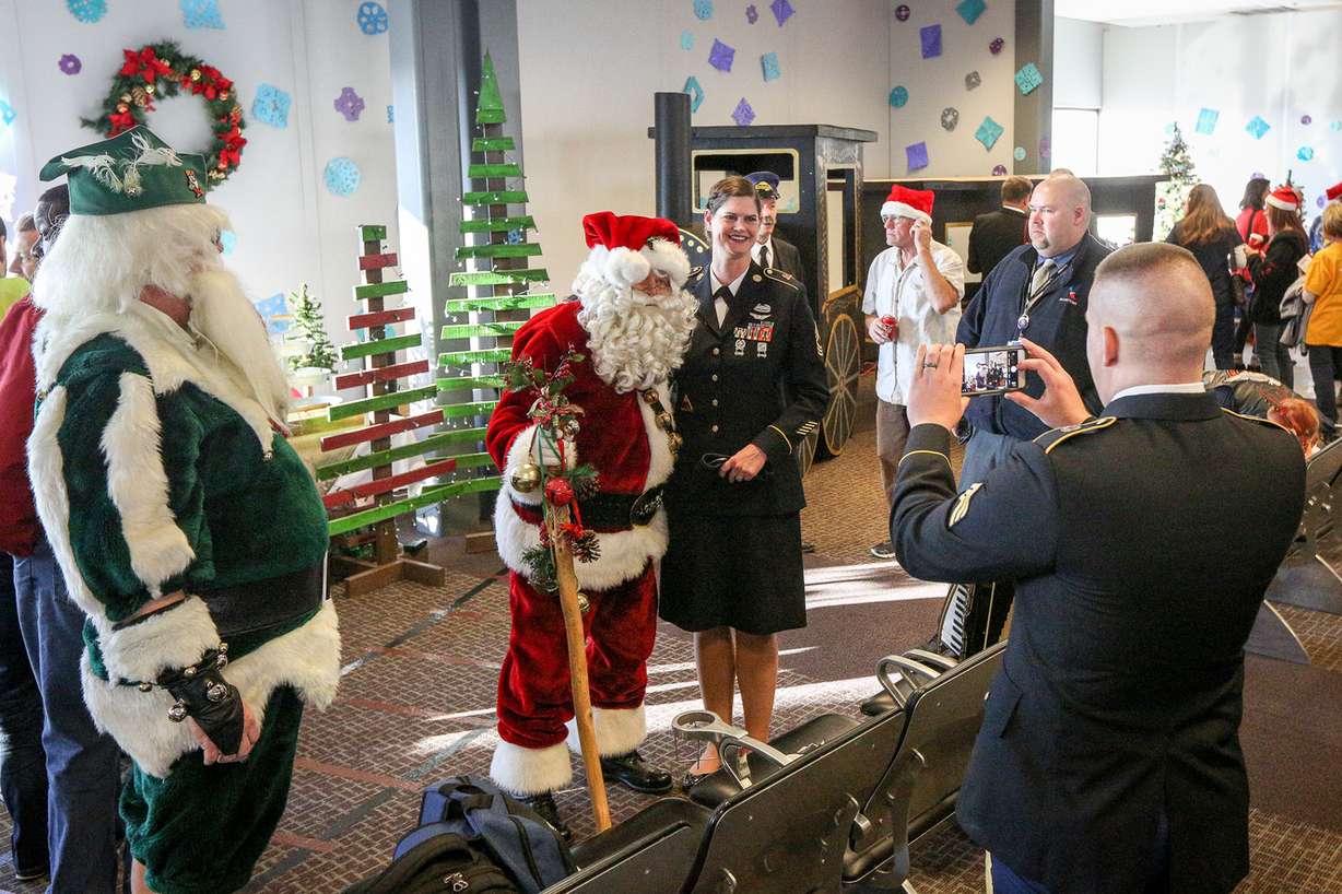 Santa takes pictures with service members during the Snowball Express at the Salt Lake City International Airport in Salt Lake City on Saturday, Dec. 9, 2017. (Photo: Adam Fondren, KSL)