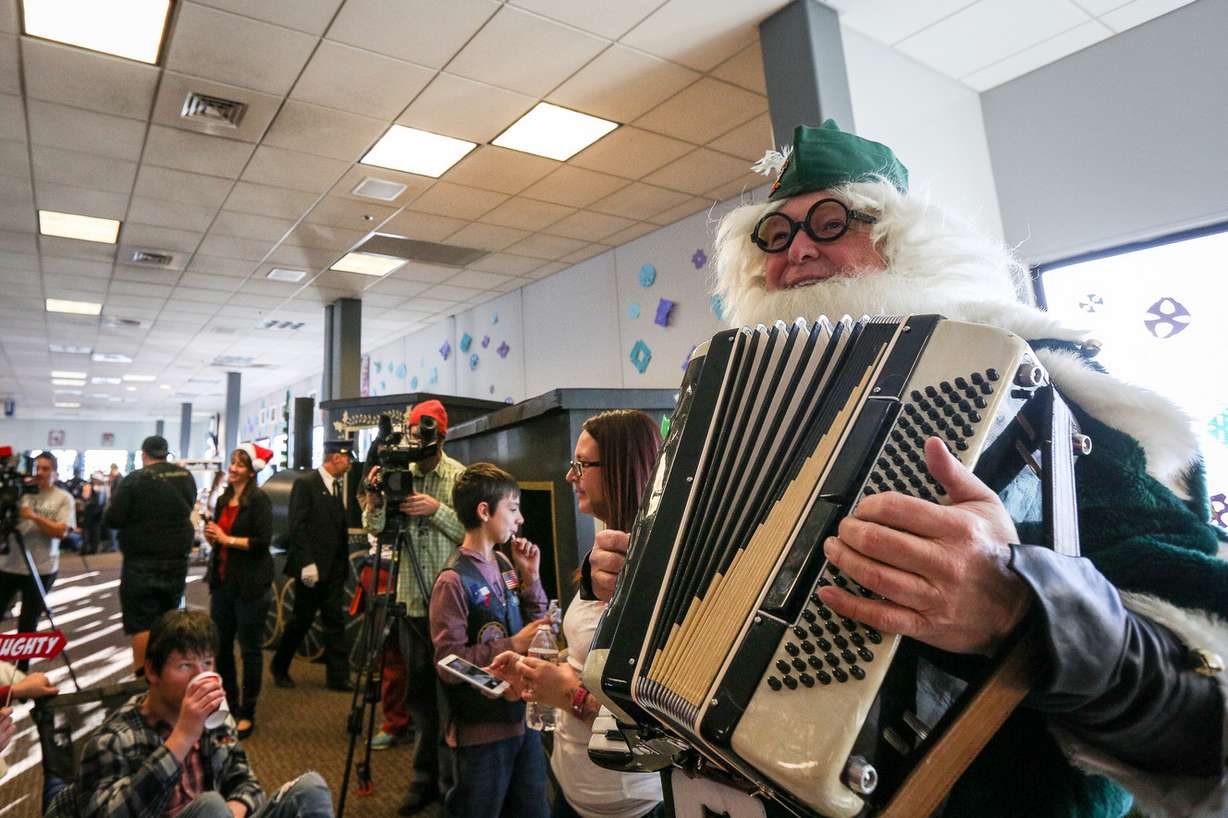 An elf plays the accordion during the Snowball Express at the Salt Lake City International Airport in Salt Lake City on Saturday, Dec. 9, 2017. (Photo: Adam Fondren, KSL)