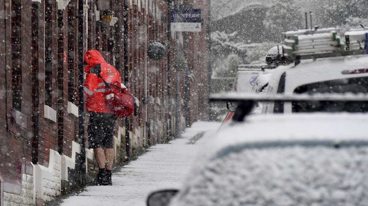 Snow disrupts road, air travel in England and northern Wales