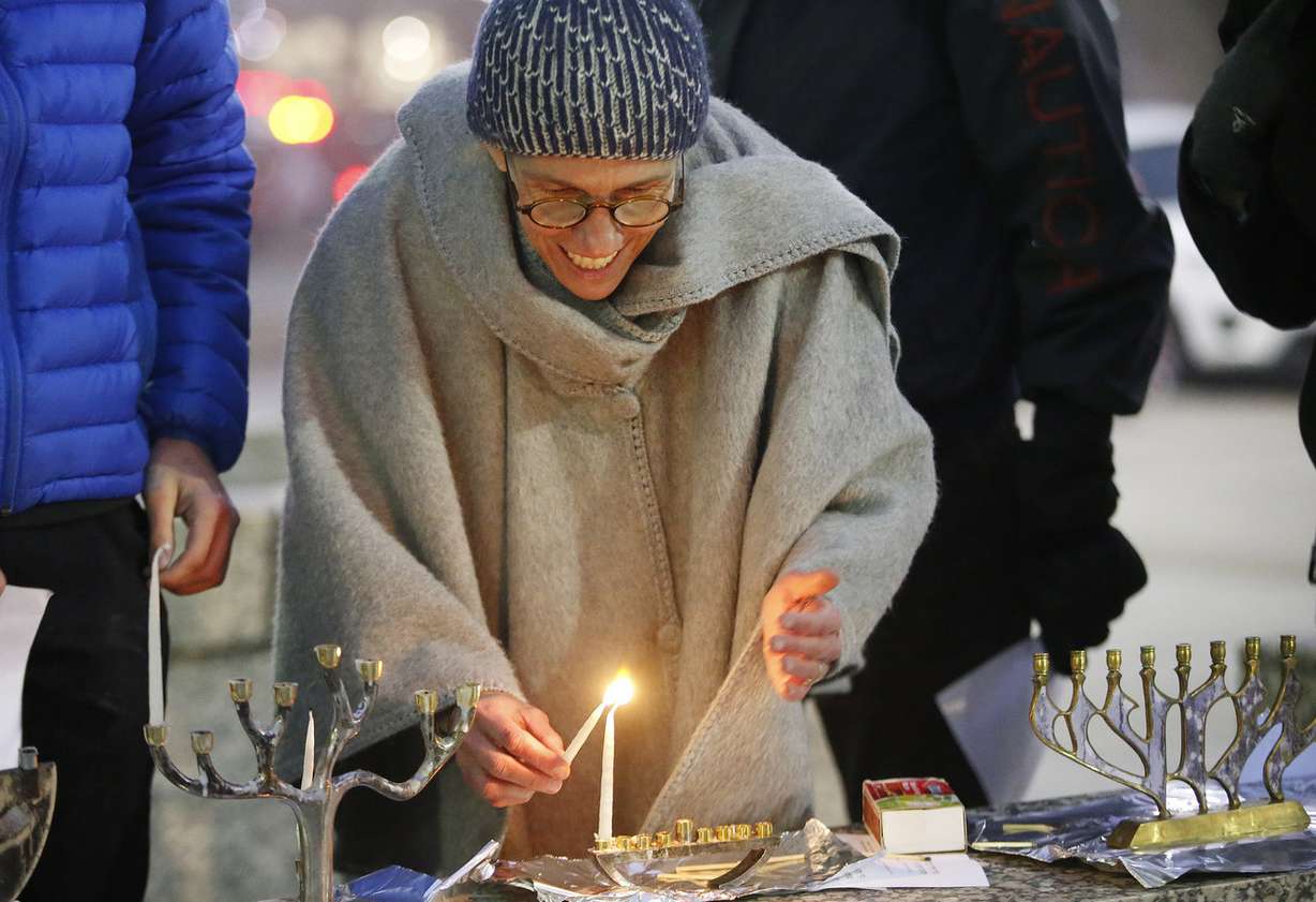 Dr. Kristine Campbell lights Hanukkah candles as Jewish Action Utah holds a rally for Children’s Health Insurance Program funding at the Wallace F. Bennett Federal Building in Salt Lake City on Tuesday, Dec. 12, 2017. (Photo: Jeffrey D. Allred, KSL)