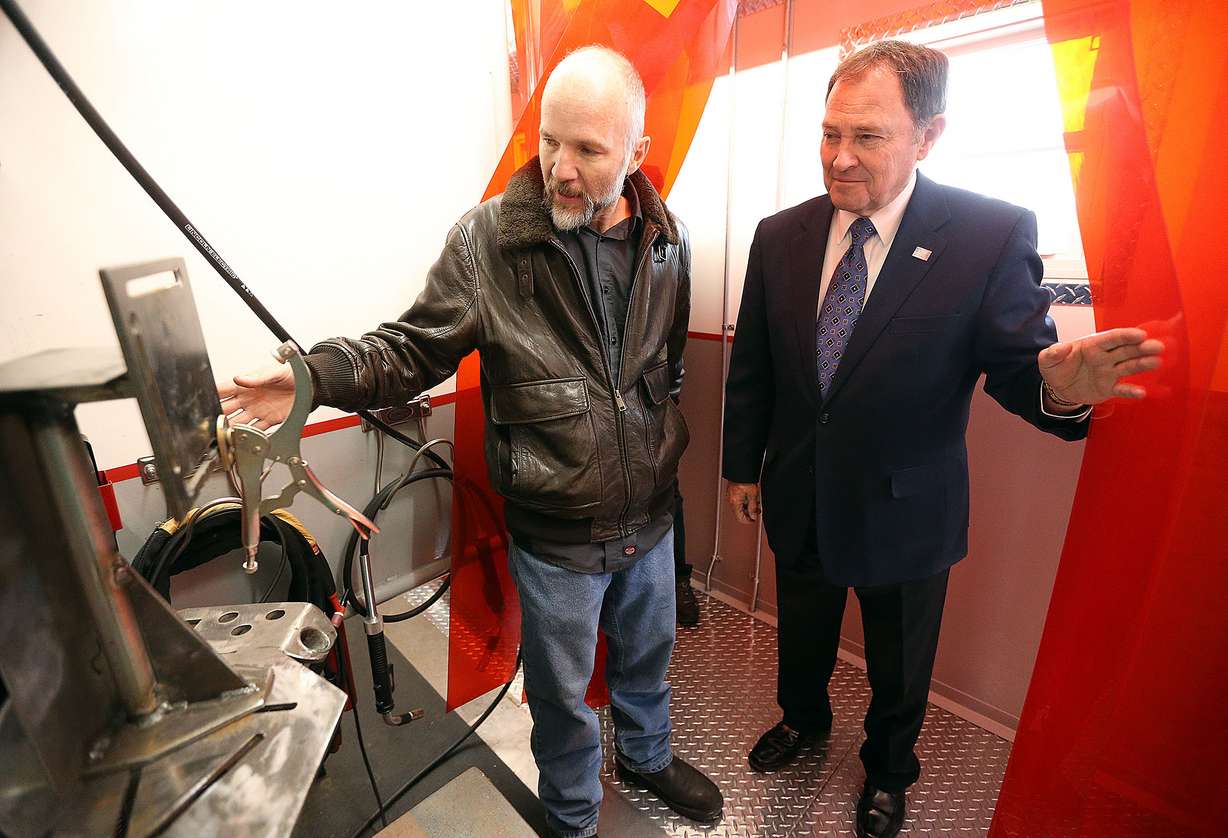 Nick Price, lead welding instructor, shows Gov. Gary Herbert a welding booth at the Davis Applied Technology Center in Kaysville on Wednesday, Dec. 13, 2017. Herbert declared 2018 as the Year of Technical Education. (Photo: Kristin Murphy, KSL)(