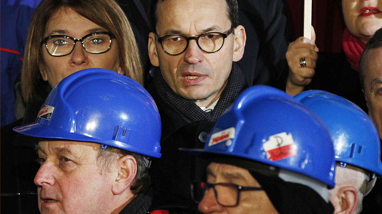 The Latest: Tusk distances himself from anti-migrant views