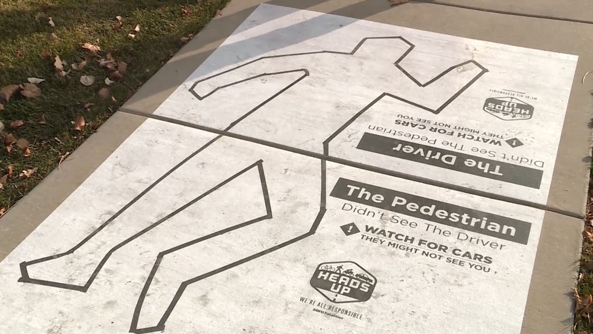 Zero Fatalities installed 20 sidewalk clings intended to remind pedestrians to stay alert when walking this holiday season. The signs are part of the “Heads Up” safety campaign. (Photo: KSL TV)