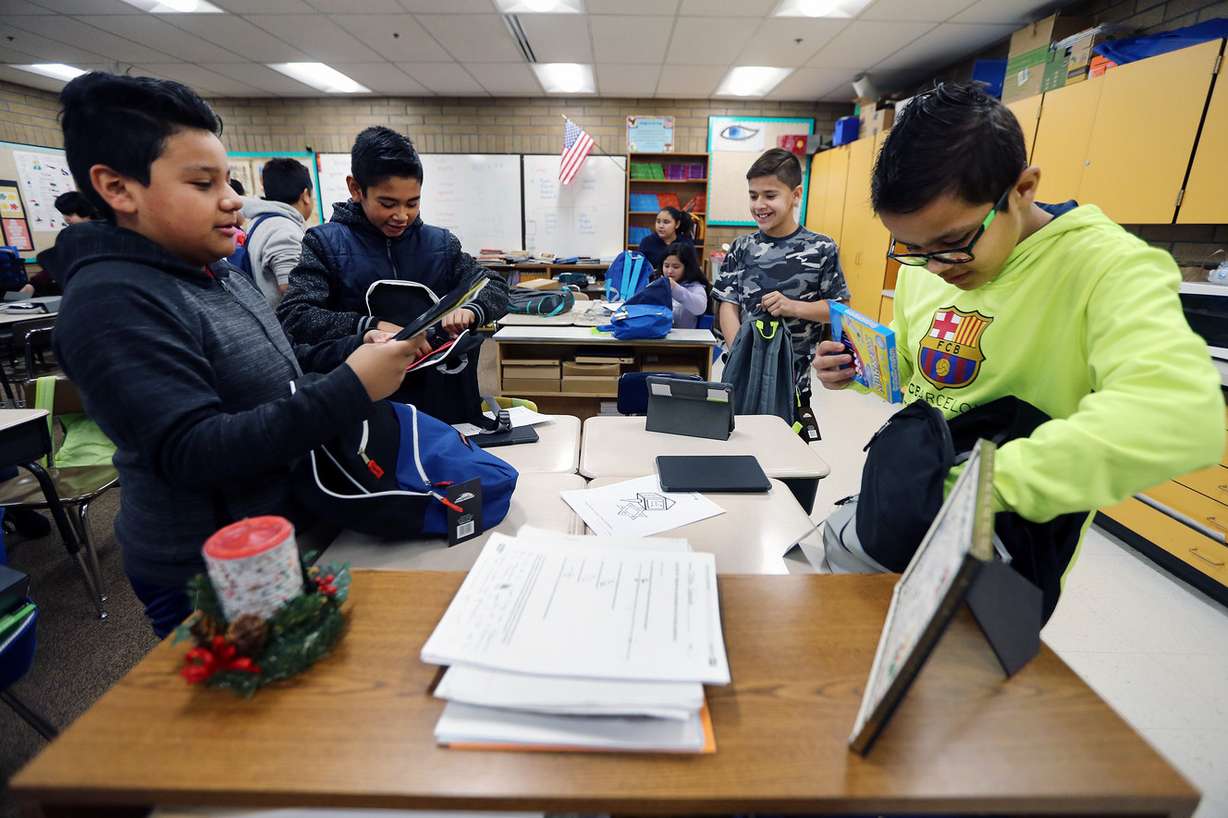 Students from Jackson Elementary School in Salt Lake City check out their new backpacks filled with supplies from Primary Residential Mortgage Inc. on Friday, Dec. 15, 2017. The company gave backpacks and supplies to all the students at Rose Park Elementary School, too. (Photo: Scott G Winterton, KSL)