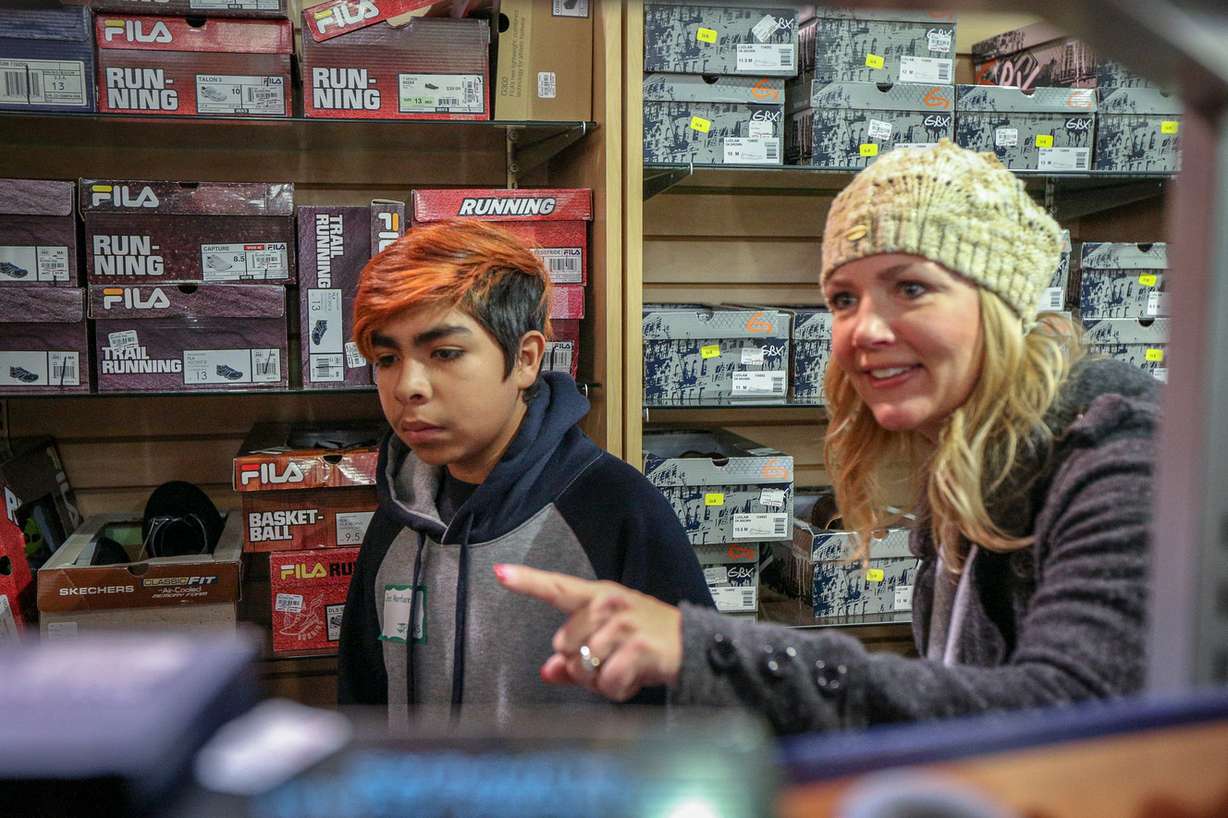 Jose Montano, left, and Tracey Vollrath shop for shoes during the Christmas for Kids shopping trip at Gordmans at the District in South Jordan on Saturday, Dec. 16, 2017. The fourth annual event was put on by the Jordan Education Fund, the South Jordan Chamber of Commerce and Gordmans. It aims to provide a $100 gift certificate to needy children in the Jordan School District to shop at the store. (Photo: Adam Fondren, KSL)