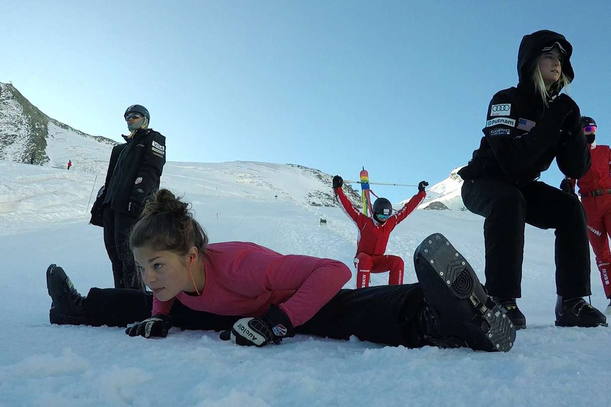Ashley Caldwell, front, and other members of the US and Swiss aerial skiing national teams warm up before training in Saas-Fee, Switzerland. Photo: John Leicester, AP Photo