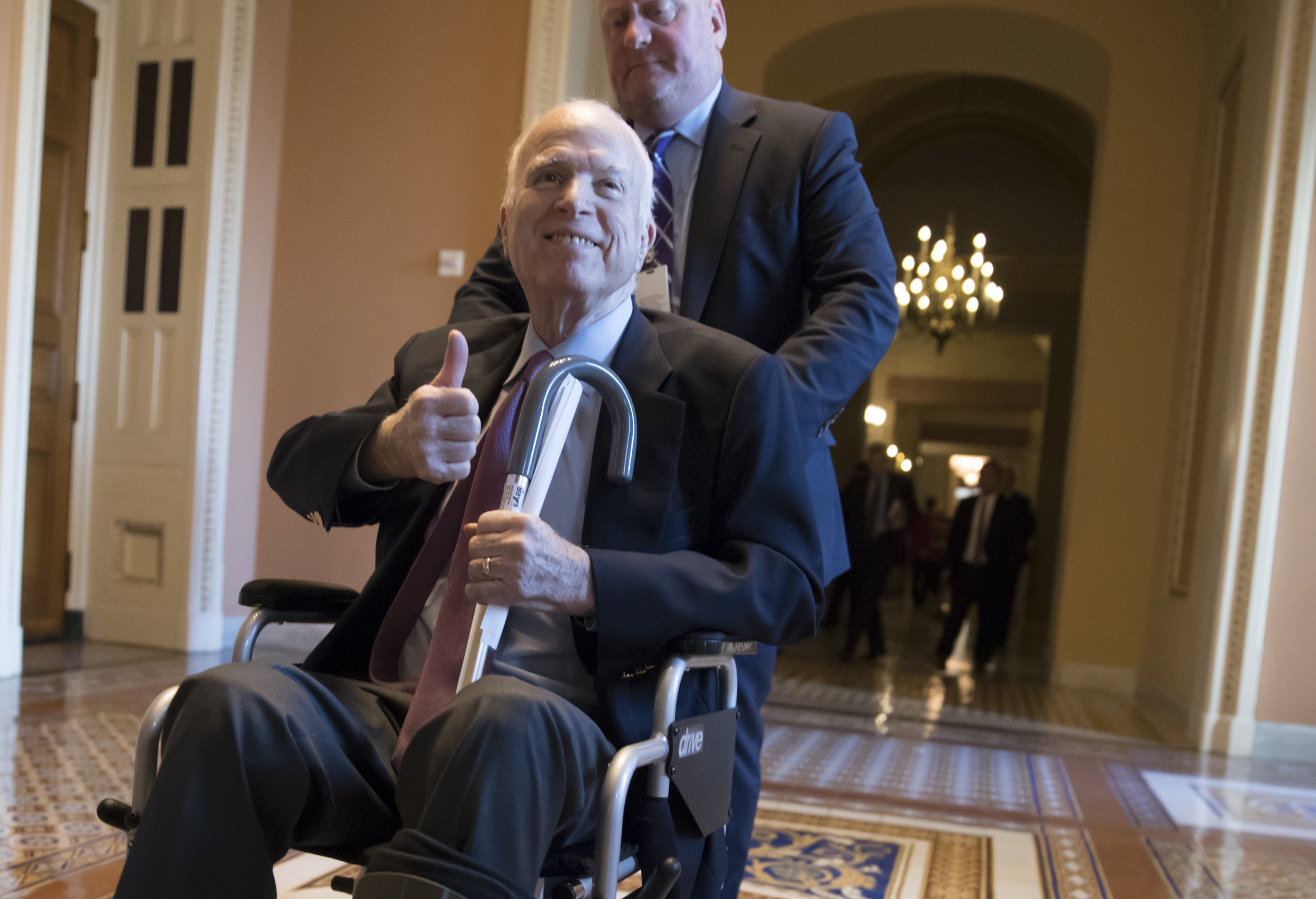 McCain says he's feeling well, vows return in January