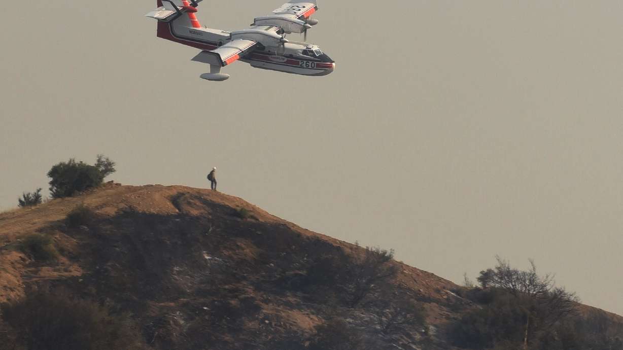 The Latest: Massive California wildfire half contained