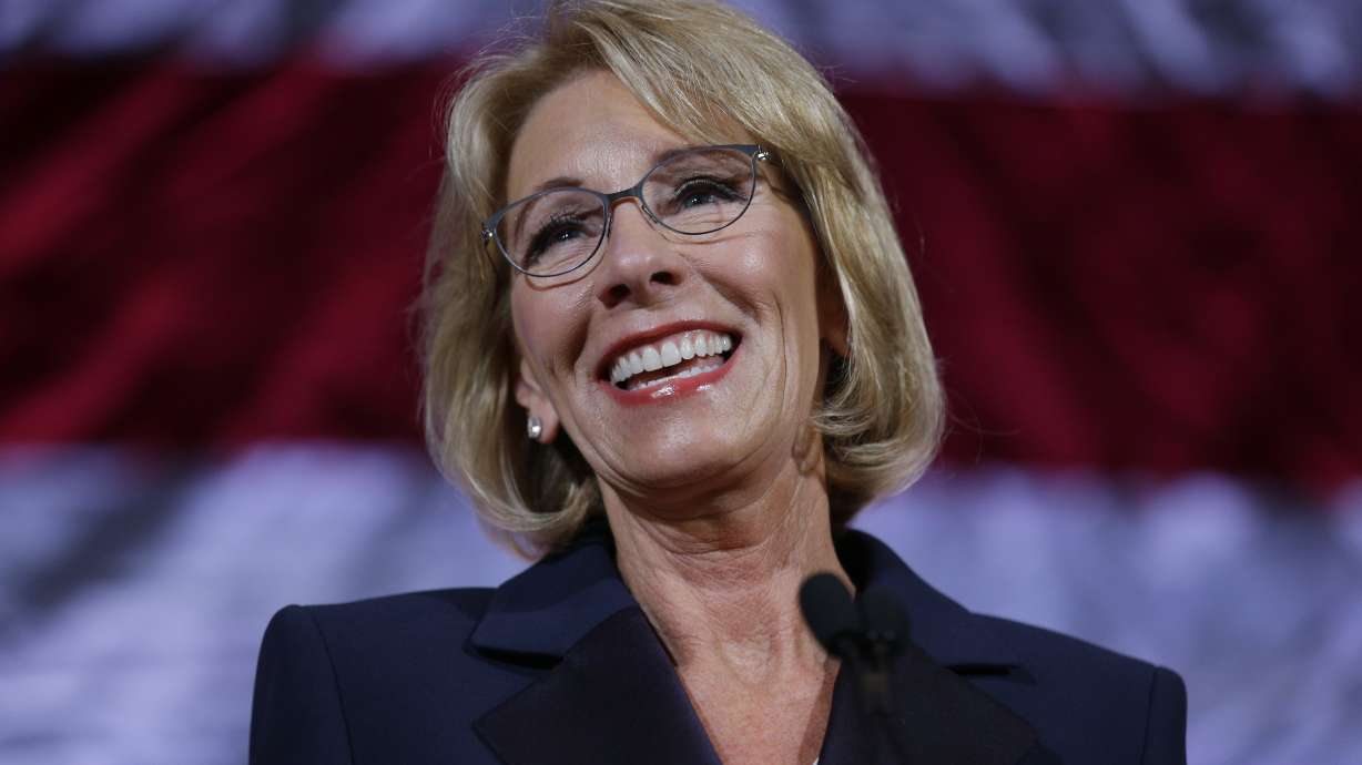 The Latest: Some in graduation crowd boo, turn from DeVos