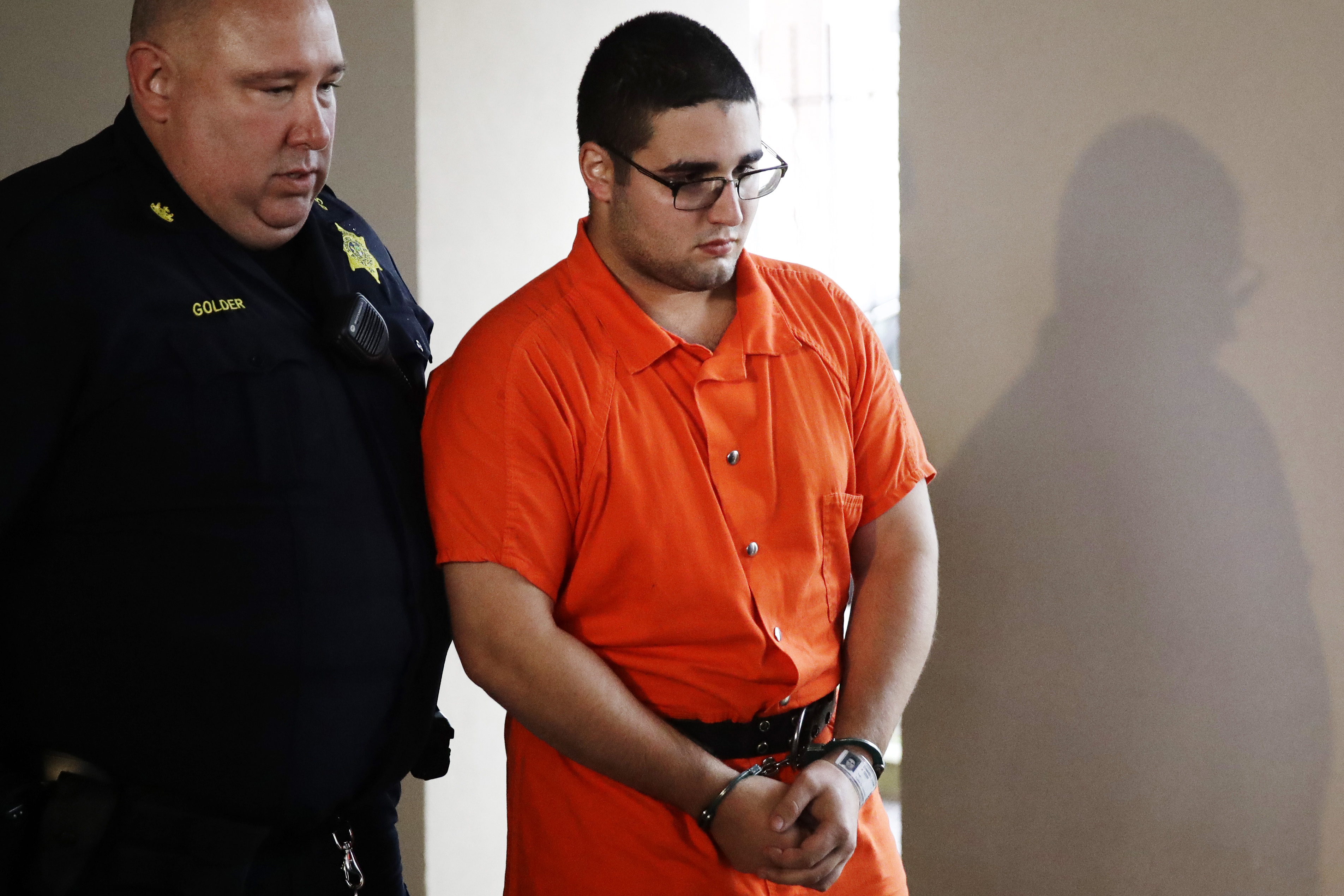 Suit blames parents of man accused of killing, burying 4