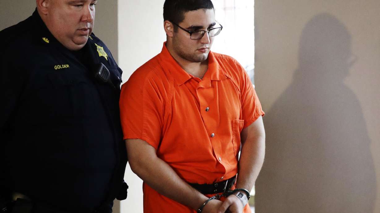 Suit blames parents of man accused of killing, burying 4