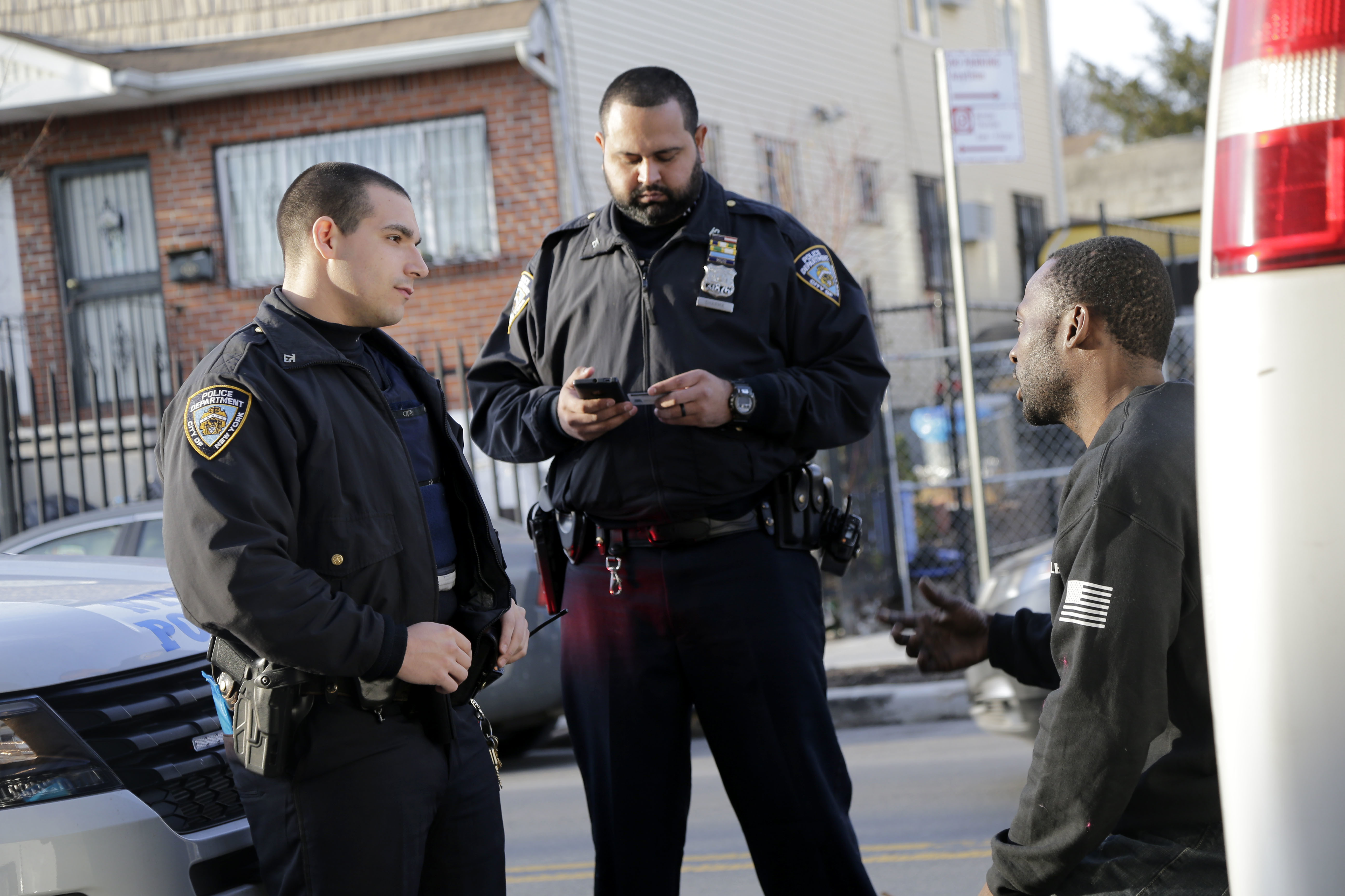 In this Tuesday, Dec. 19, 2017 photo, police officers Jimmy Priore, left, and Manny Sharma talk with a driver who was pulled over for an invalid registration in the Brooklyn borough of New York. Photo: AP Photo