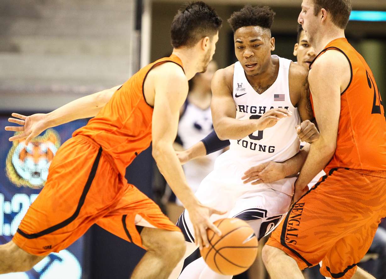 BYU guard Jahshire Hardnett (0) gets caught in the screen by Idaho State forward Blake Truman (24) as Idaho State guard Geno Luzcando (1) dribbles past as BYU takes on Idaho State at the Marriot Center in Provo on Thursday, Dec. 21, 2017. (Photo: Adam Fondren, Deseret News)