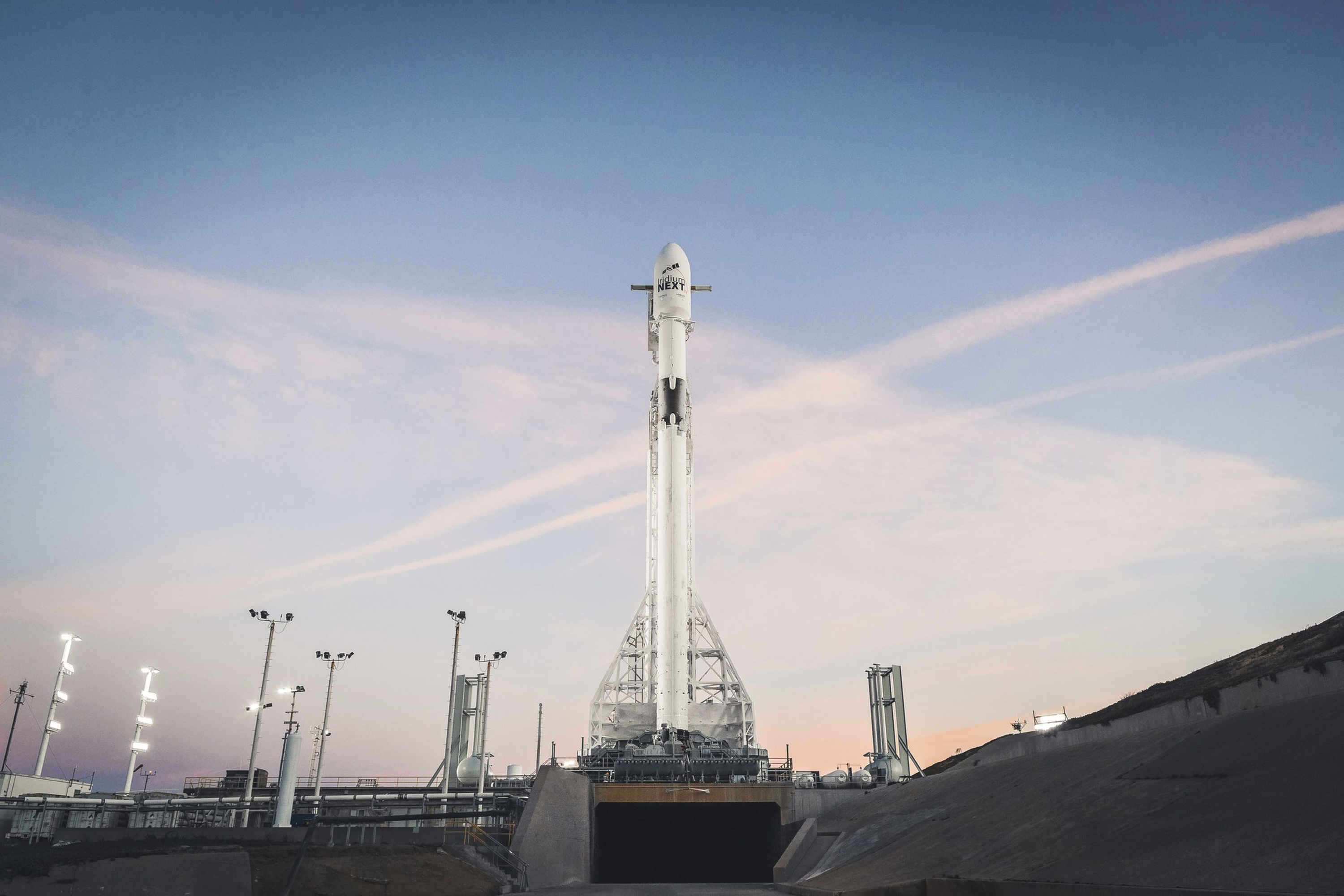 Rocket lights sky as it carries satellites from California