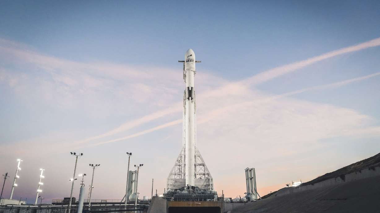 Rocket lights sky as it carries satellites from California